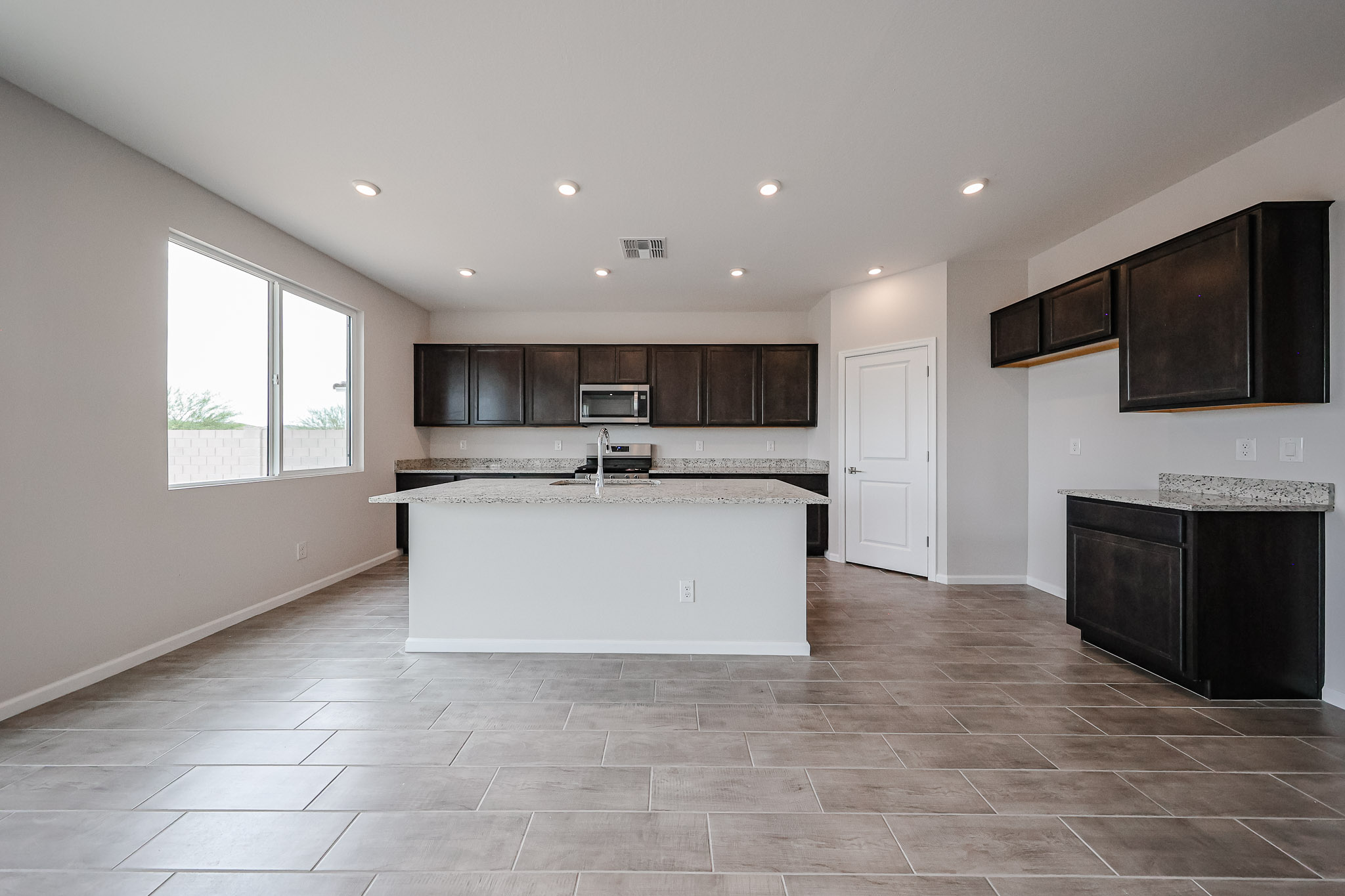 A large kitchen with a large white counter top.