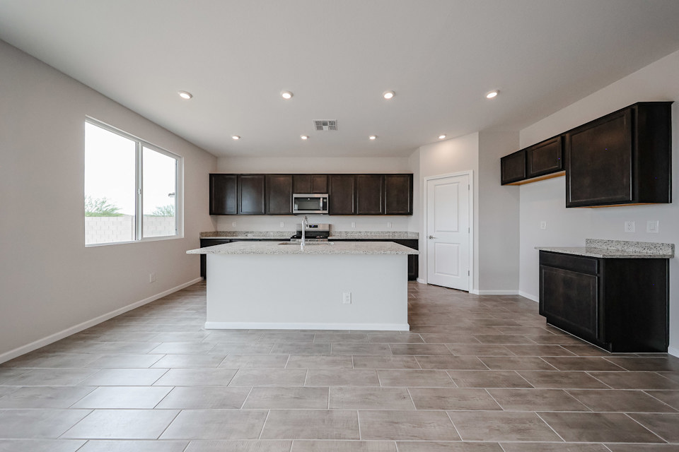 A large kitchen with a large white counter top.