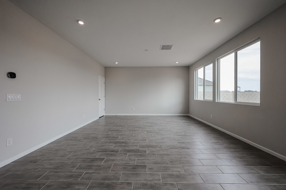 A room with a tile floor and windows.