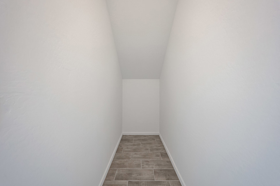 A hallway with white walls.