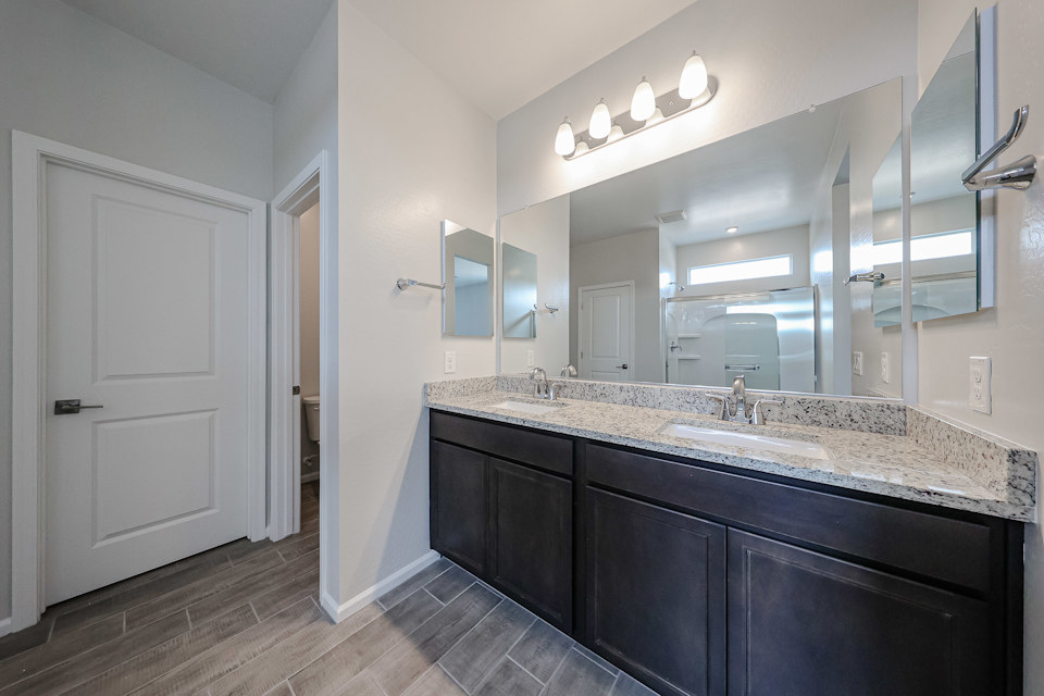 A bathroom with a large mirror.