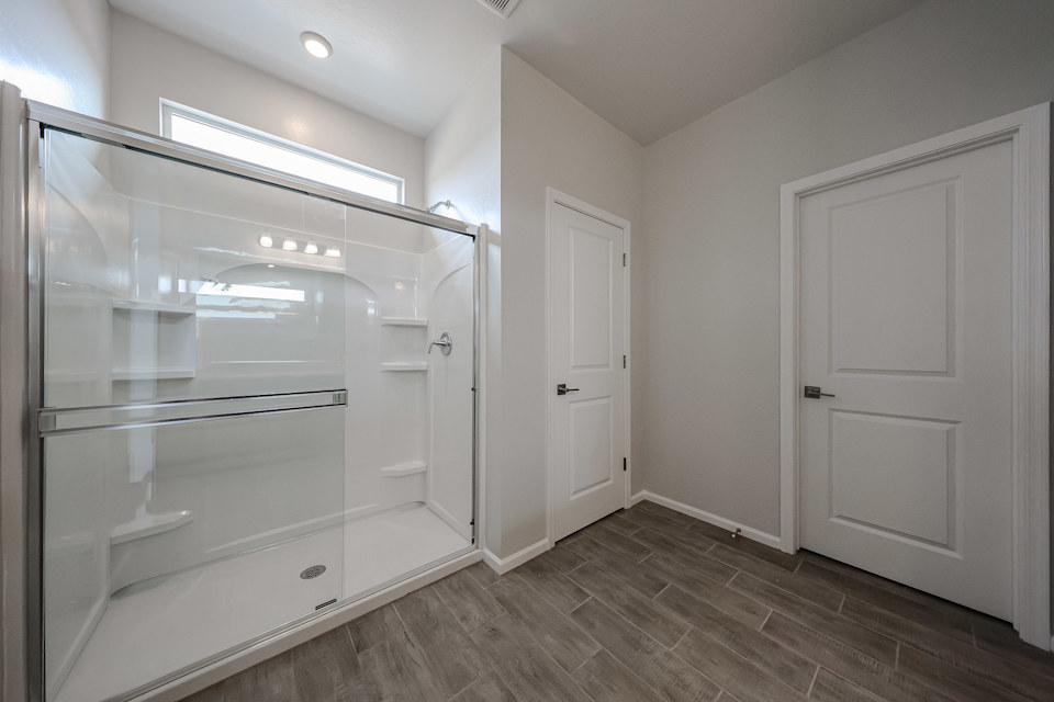 A bathroom with white cabinets.