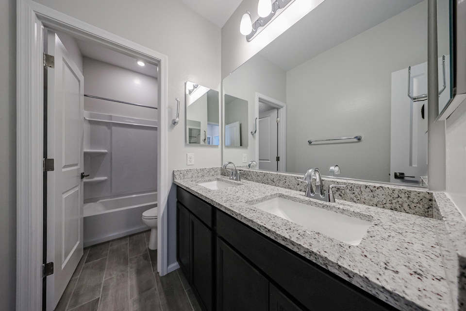 A bathroom with a marble countertop.