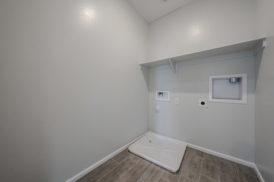 A white room with a tile floor.