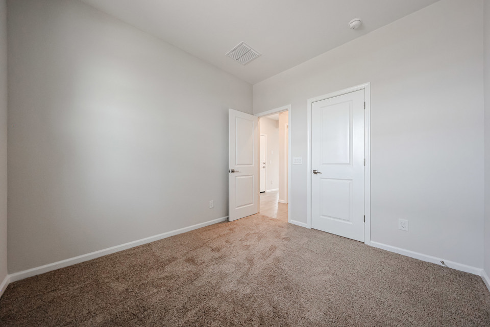A hallway with white doors.