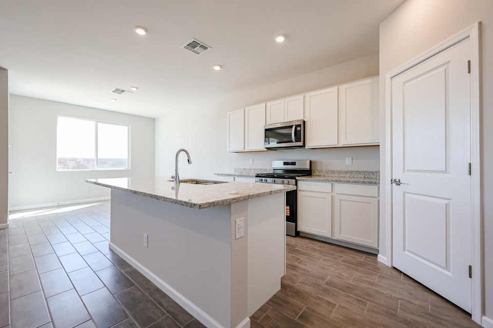 A kitchen with white cabinets.