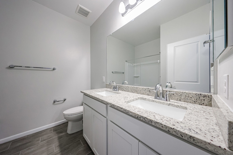A bathroom with a marble countertop.