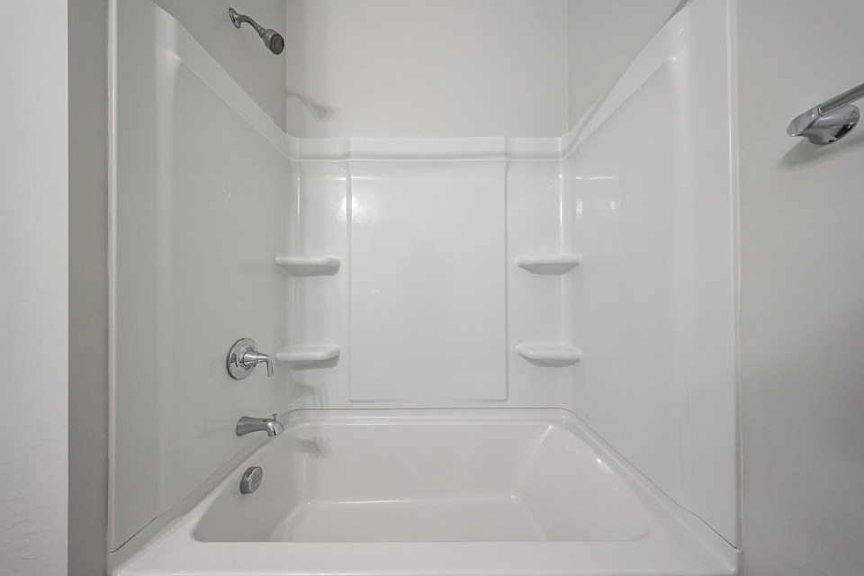 A bathtub in a bathroom.