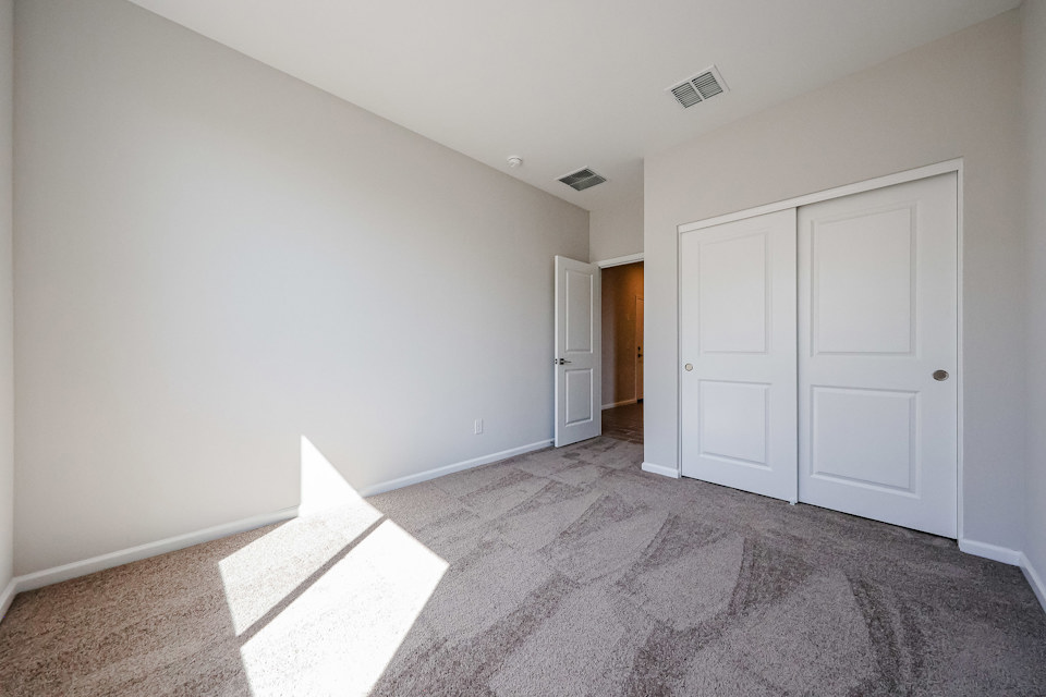 A hallway with white doors.