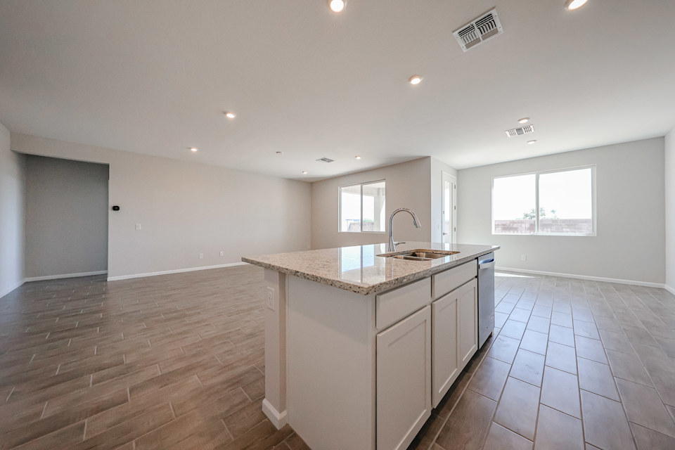 A kitchen with a marble countertop.