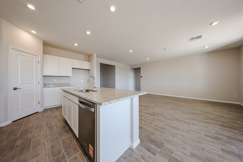 A kitchen with white cabinets.