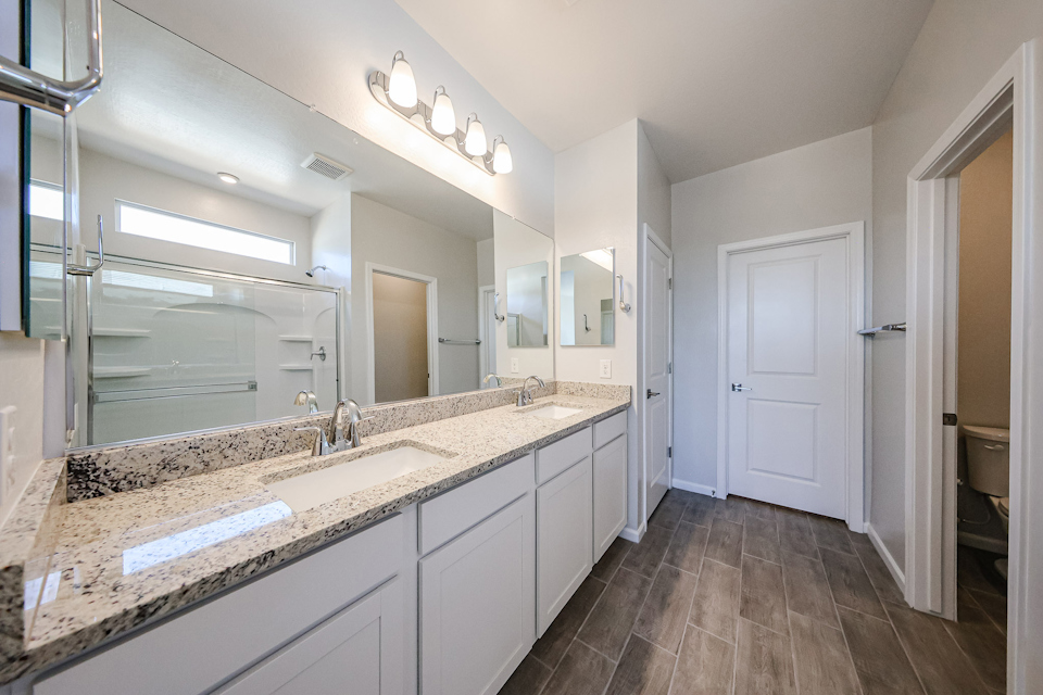 A bathroom with a large mirror.