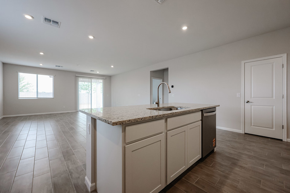 A kitchen with a marble countertop.