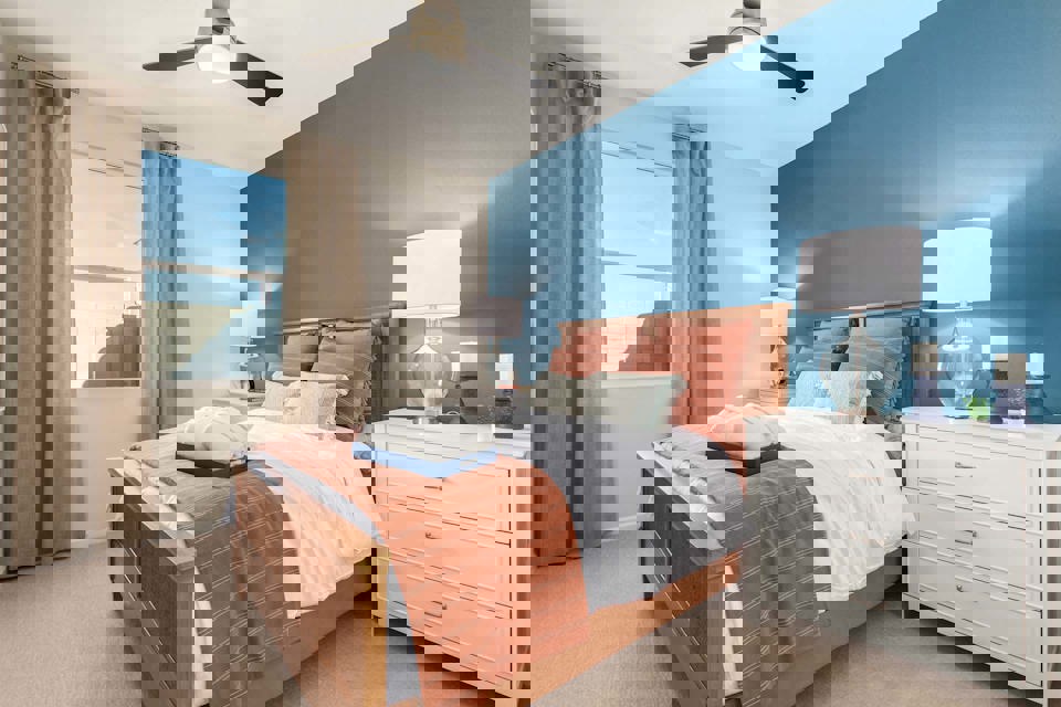 A bedroom with a large window.