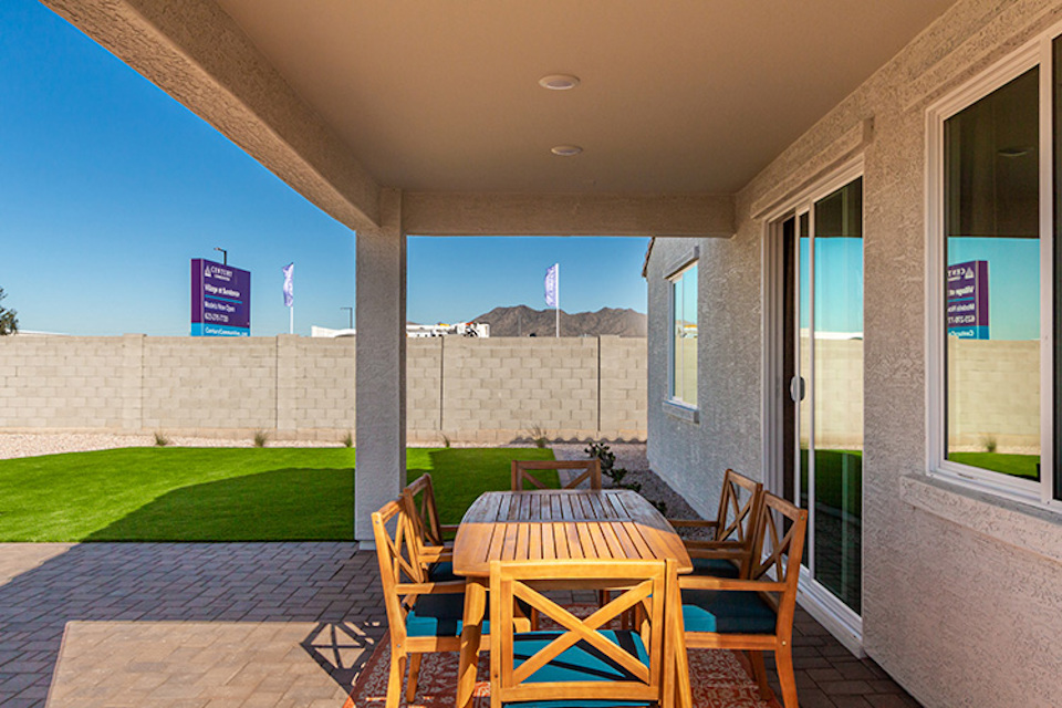 A patio with a table and chairs.