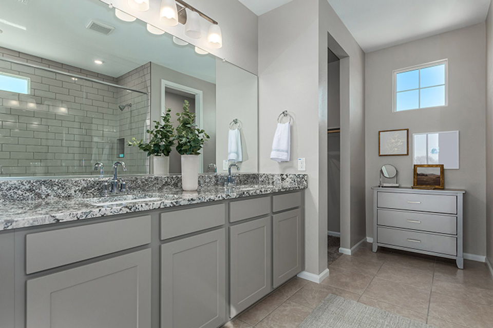 A bathroom with a large mirror.