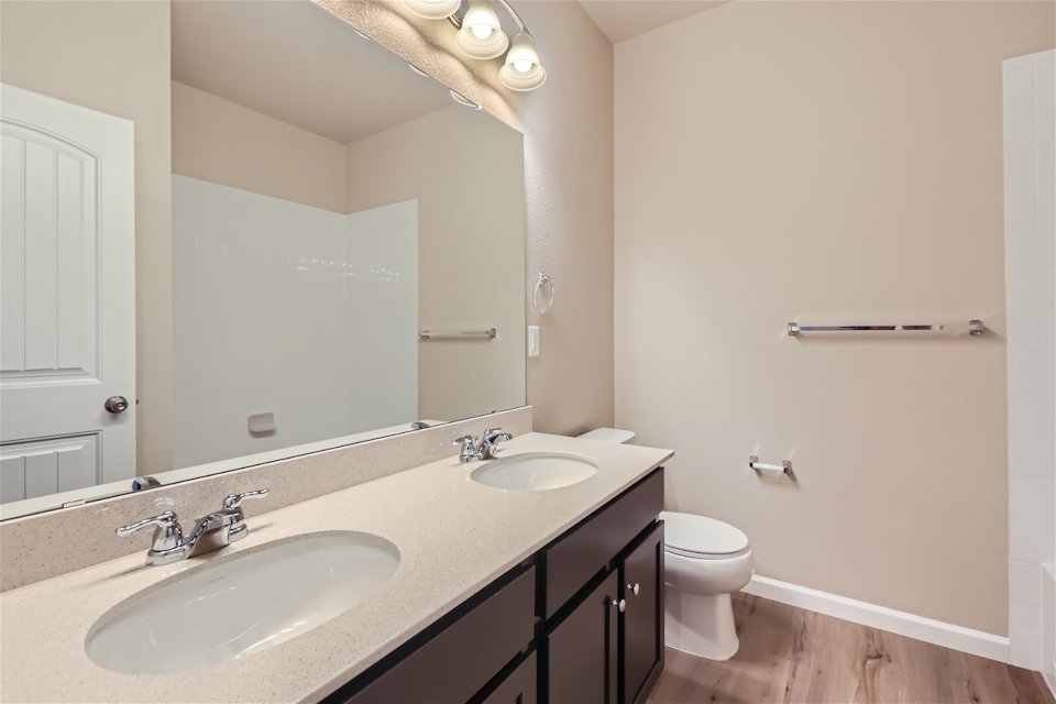 A bathroom with a large mirror.