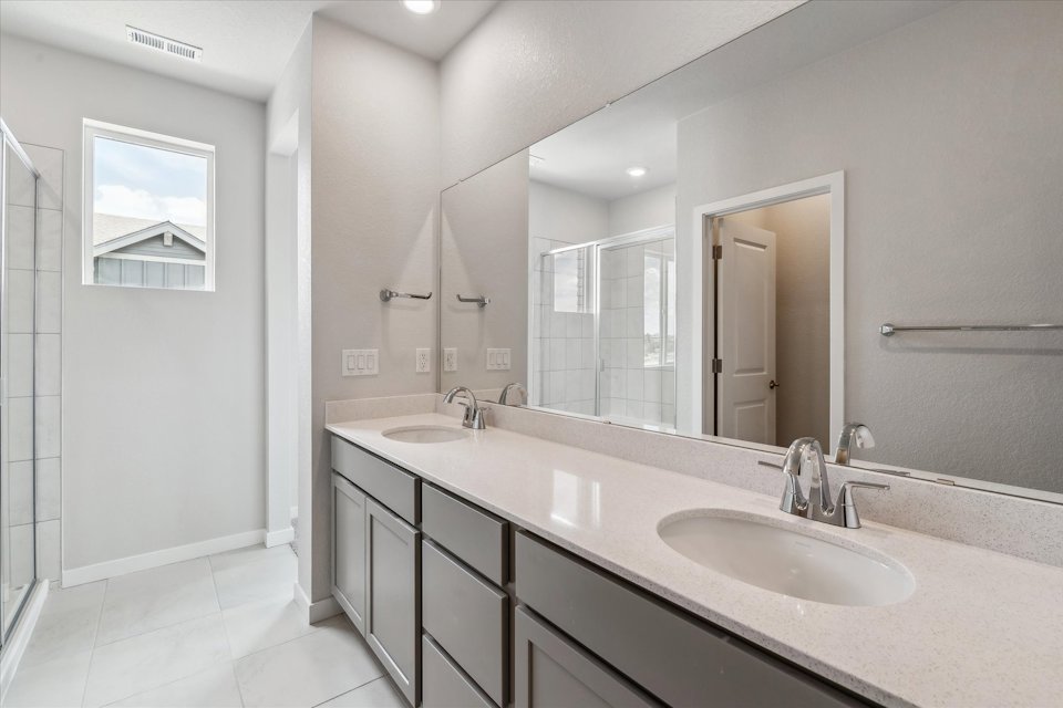 A bathroom with a large mirror.