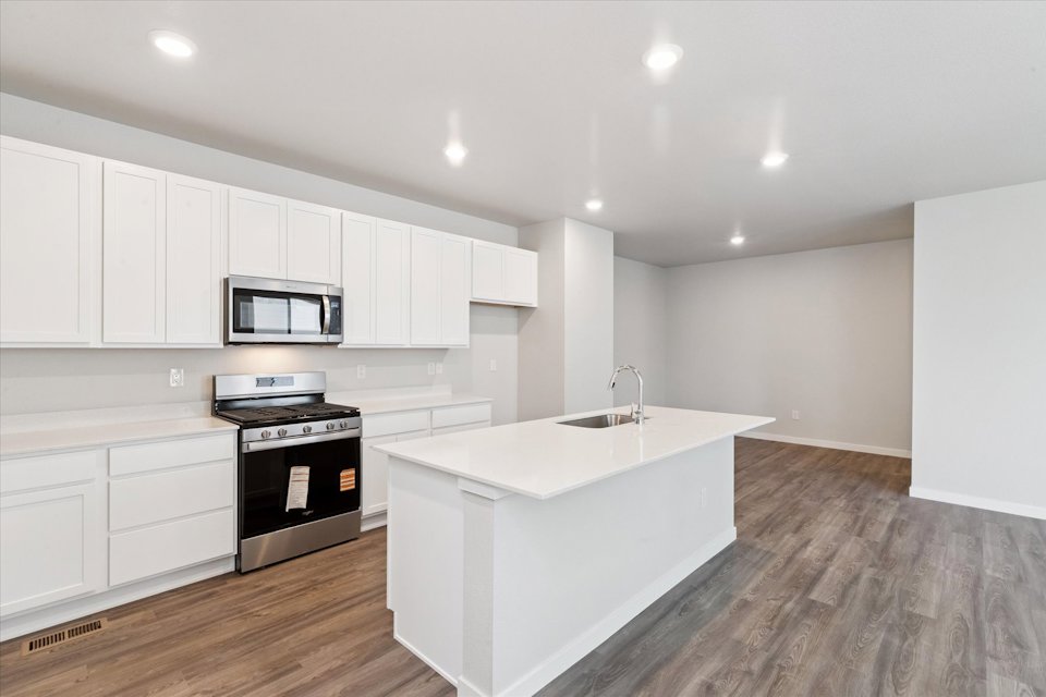 A kitchen with white cabinets.