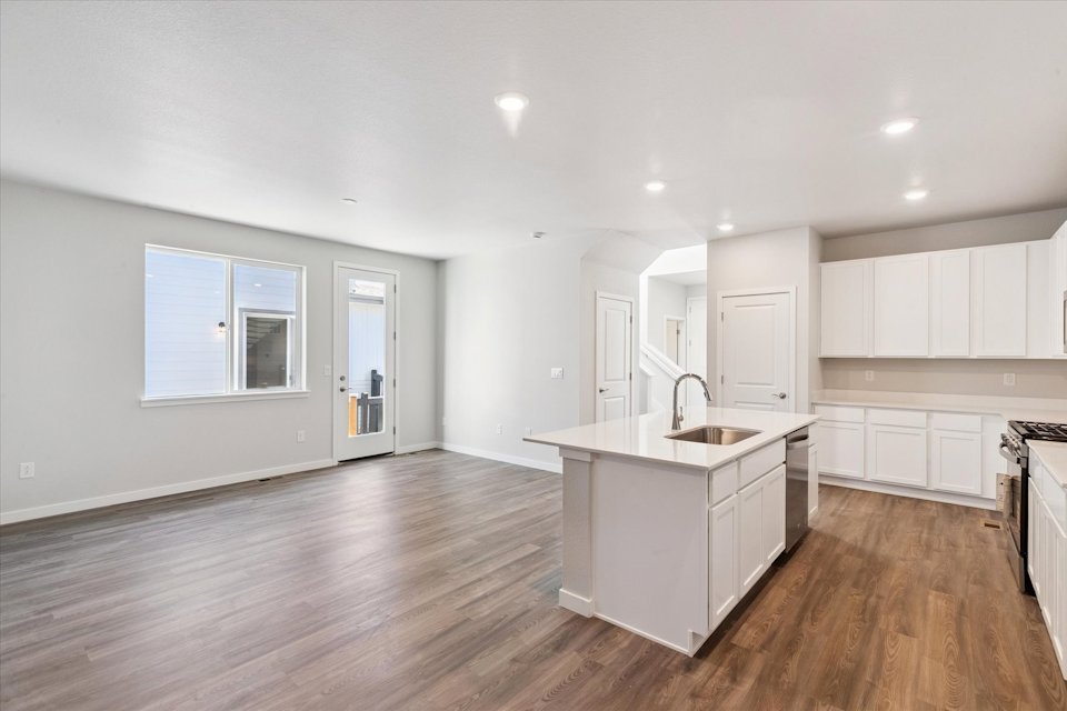 A kitchen with white cabinets.