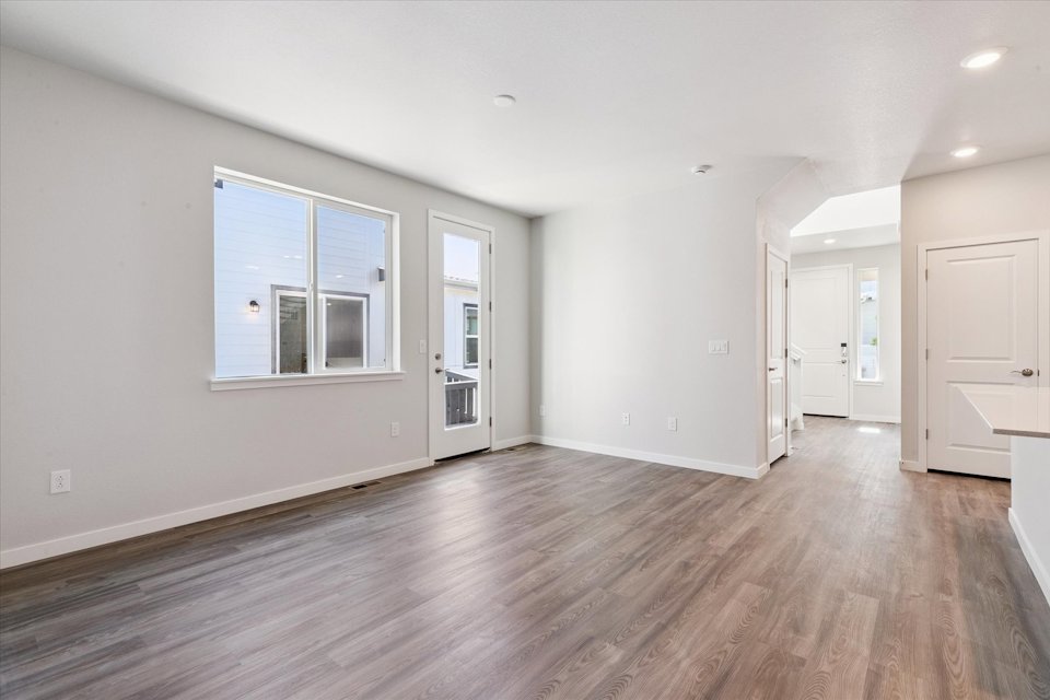 A room with white walls and wood floors.