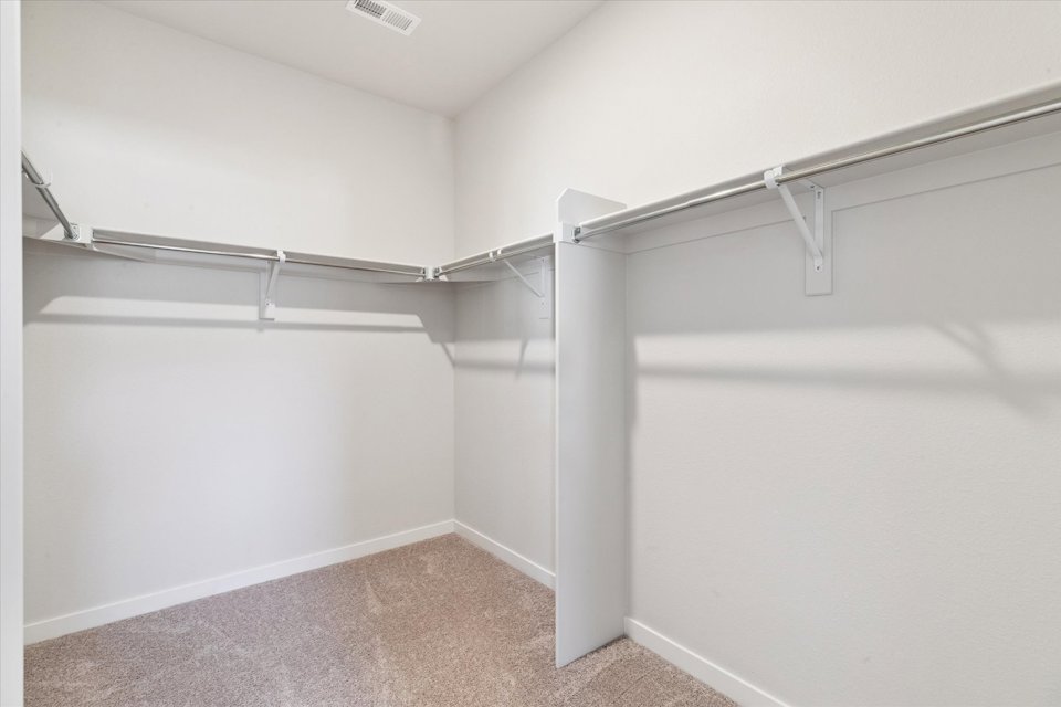 A white wall with a metal railing.