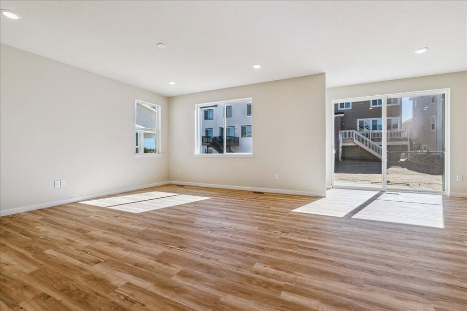 A room with a wood floor and windows.