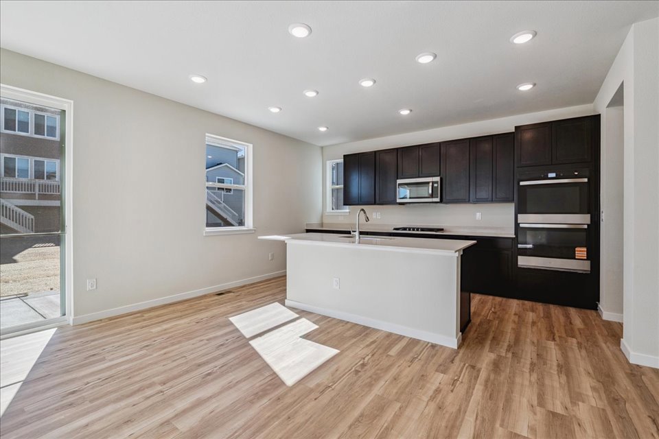 A kitchen with black cabinets.