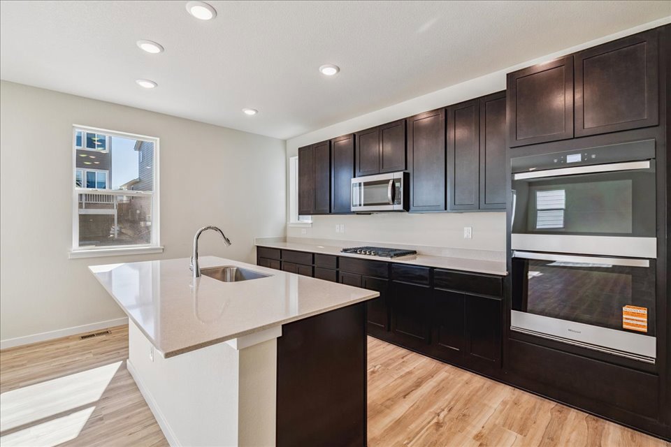 A kitchen with black cabinets.