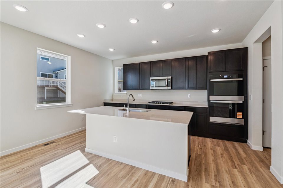 A kitchen with black cabinets.