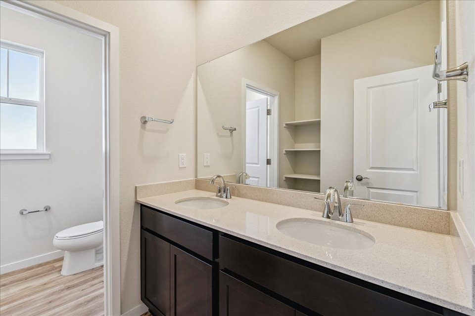A bathroom with a large mirror.