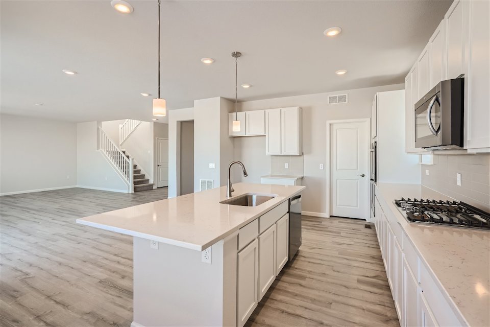 A kitchen with white cabinets.