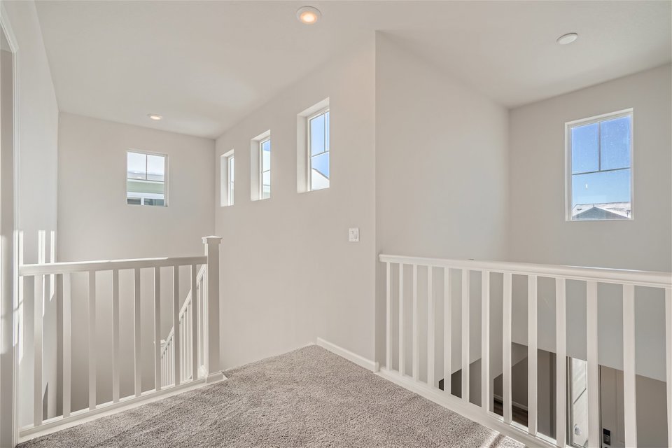 A white room with a white railing.