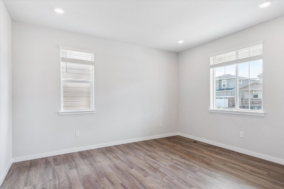 A room with a wood floor and a window.