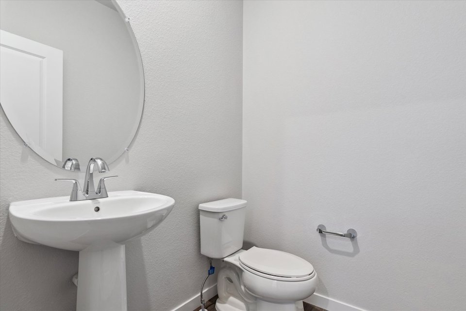A bathroom with a toilet and sink.