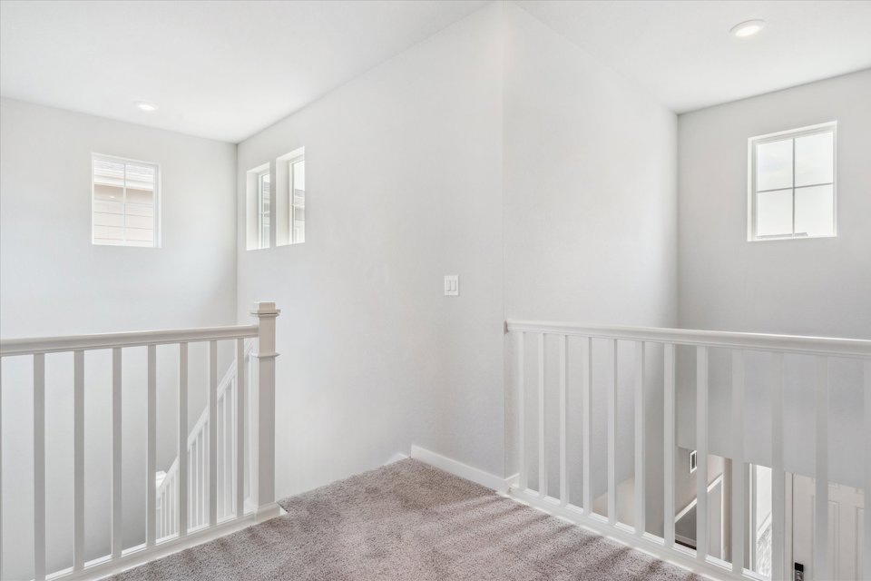 A white room with a railing.
