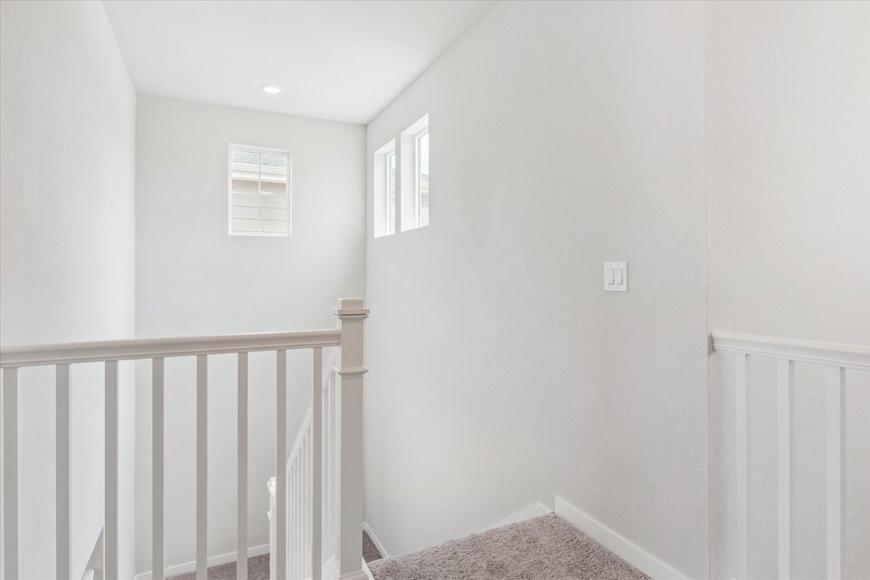 A white room with a railing.