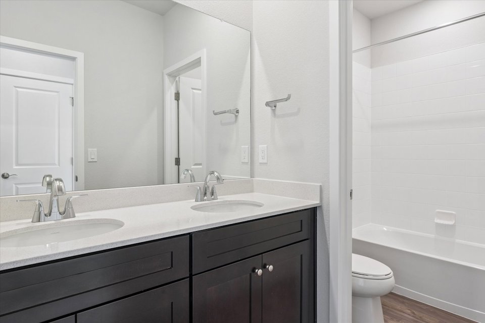 A bathroom with a sink toilet and bathtub.