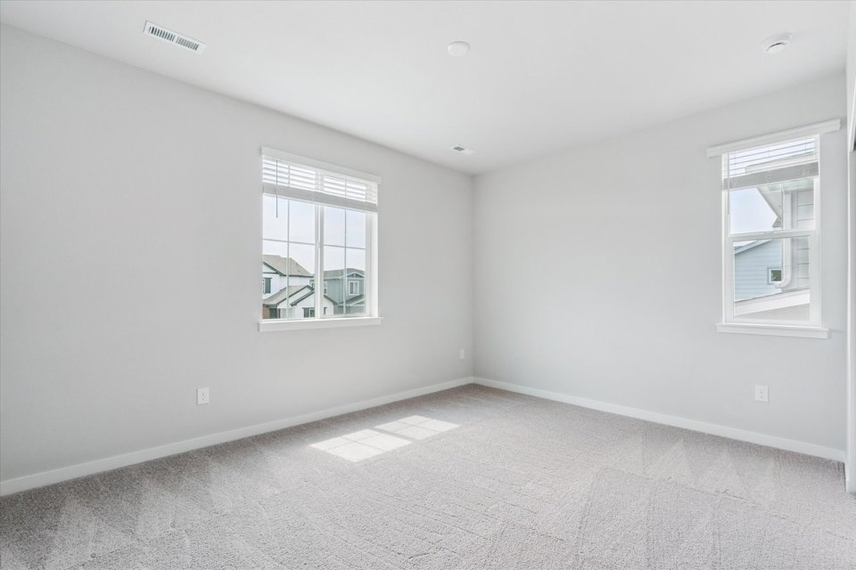 A room with windows and a tile floor.