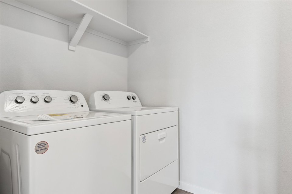 A washing machine in a room.