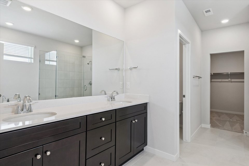 A bathroom with a large mirror.