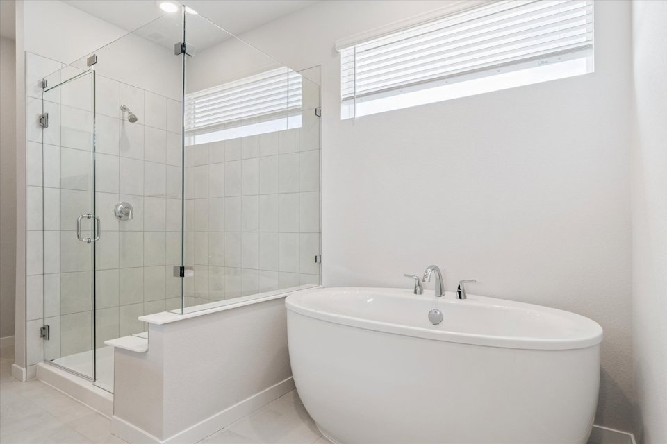 A bathroom with a tub and shower.