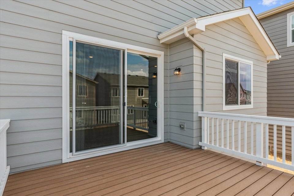 A white house with a deck.