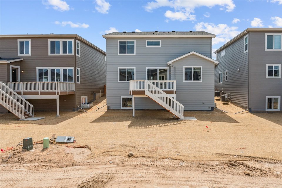 A dirt yard with houses.