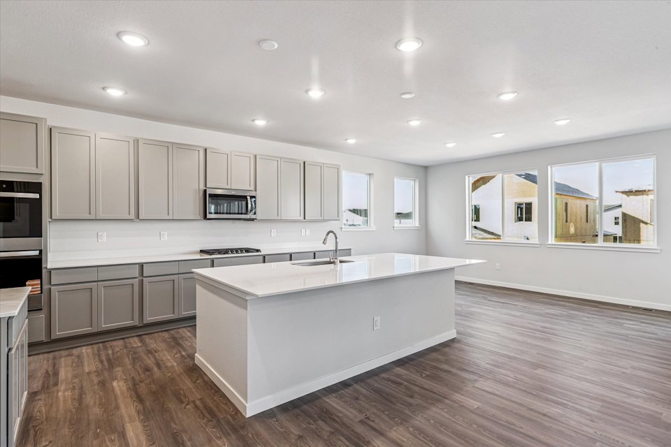 A kitchen with white cabinets.