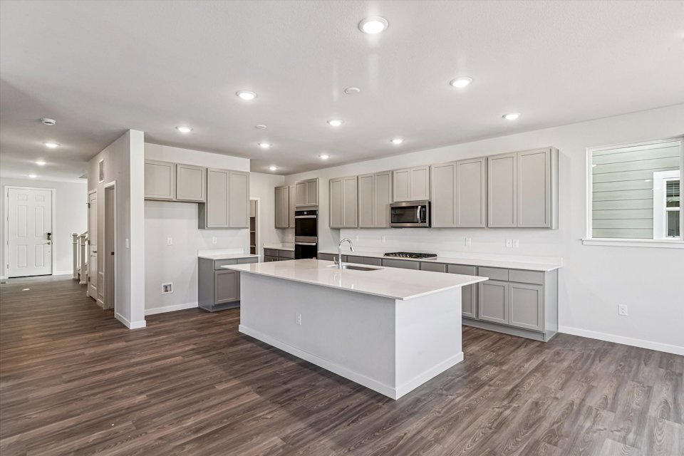 A kitchen with white cabinets.