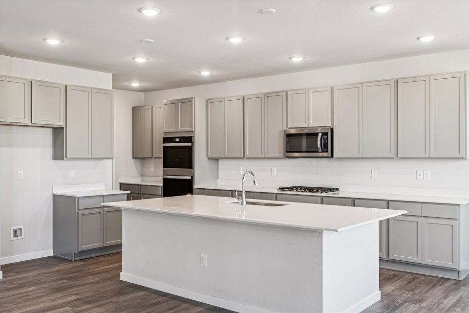 A kitchen with white cabinets.