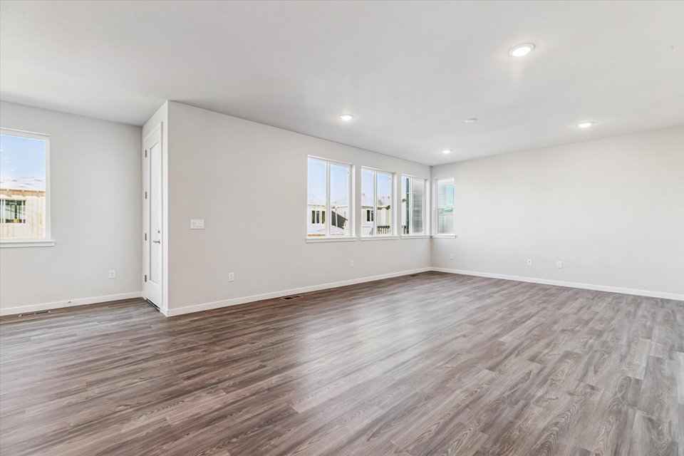 A room with a wood floor and white walls.