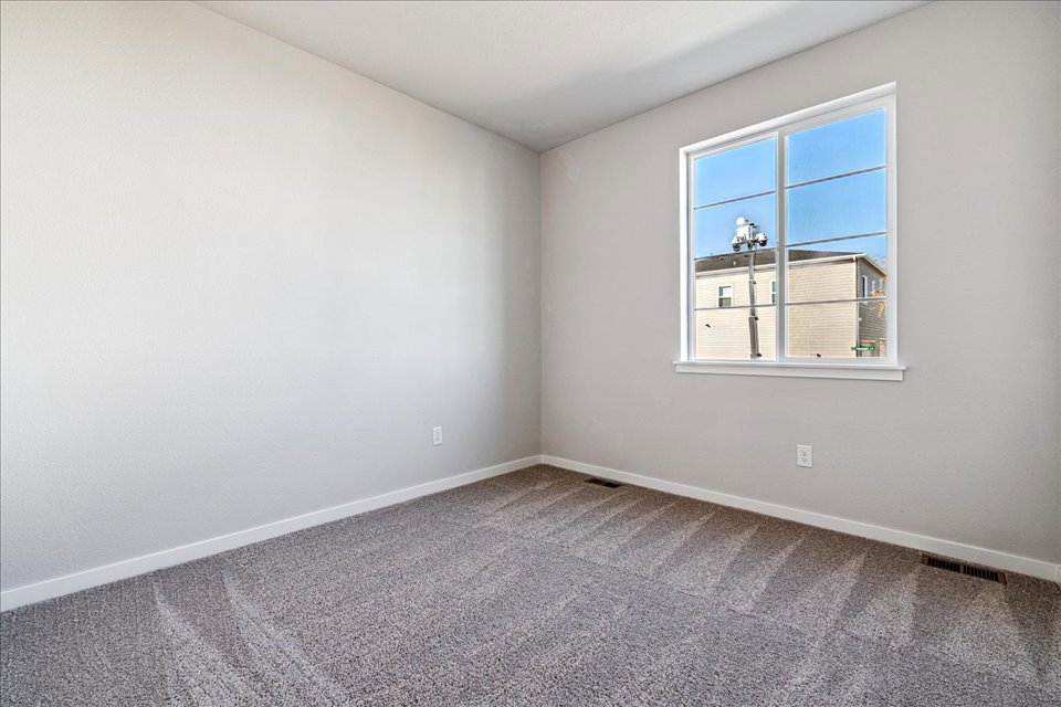 A room with a window and a carpet.