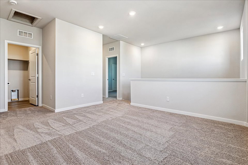 A room with a carpet and a door.